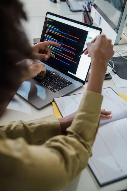 A modern workspace with a smartphone displaying a screen and a computer setup, ideal for business and technology themes.